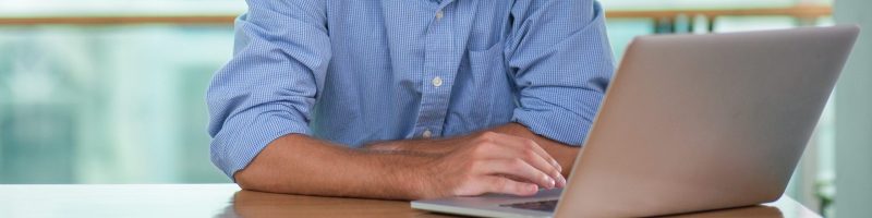 focused-bearded-man-working-laptop-cafe